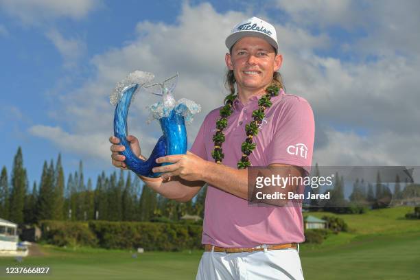 Cameron Smith of Australia holds the trophy on the 18th green after the final round of the Sentry Tournament of Champions on the Plantation Course at...