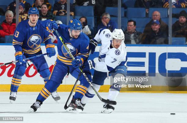 Will Butcher of the Buffalo Sabres and Mathieu Joseph of the Tampa Bay Lightning battle for the puck during an NHL game on January 11, 2022 at...