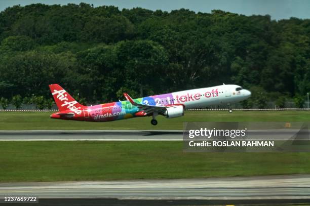 An AirAsia plane takes off from Singapore Changi Airport in Singapore on January 12, 2022.