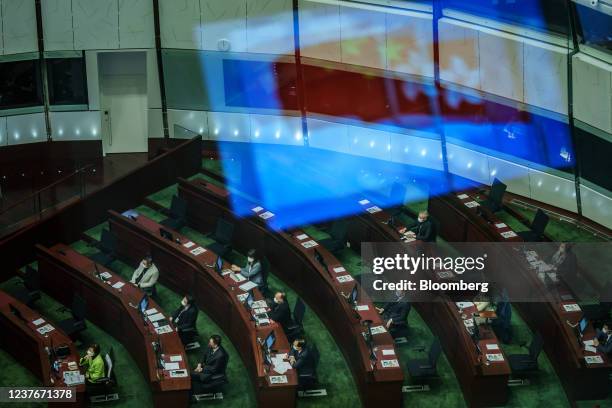 An image of the flags of China, left, and the Hong Kong Special Administrative Region reflected on the window during a Question and Answer session in...