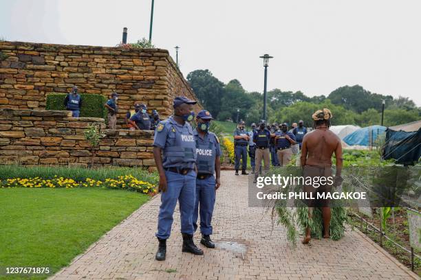 King Khoisan South Africa stands with a marijuana plant that he held onto as South African Police Services members confiscated the plants during a...