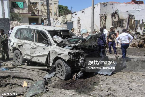 General view of the scene of a car-bomb explosion in Mogadishu on January 12, 2022 where at least six people were killed and several others wounded...