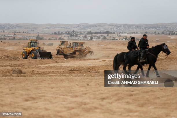 Israeli mounted police monitor the situation as Bedouins protest in the southern Israeli village of Sawe al-Atrash in the Neguev Desert against an...