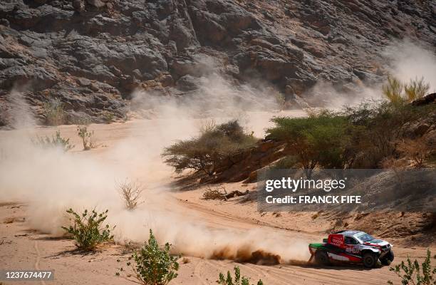 Toyota's driver Yazeed Al Rajhi of Saudi Arabia and co-driver Britain's Michael Orr compete during the Stage 10 of the Dakar Rally 2022 between Wadi...