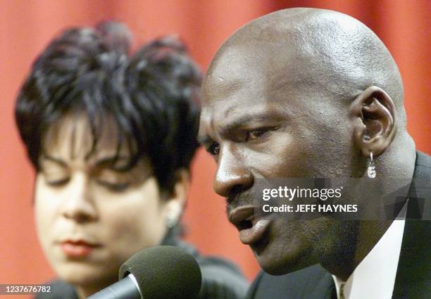 Michael Jordan of the Chicago Bulls sits with his wife Juanita as he speaks at his press conference 13 January to announce he is retiring from the...