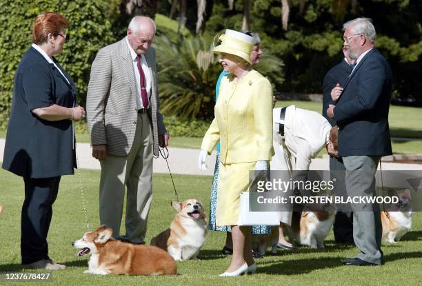 Queen Elizabeth II meets members of the Adelaide Hills Kennel Club and their corgis at Government House in Adelaide, 28 February 2002 before visiting...