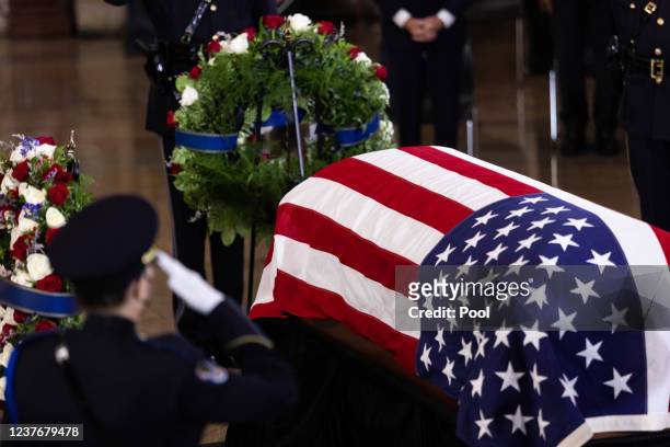 Police officer salutes as the casket of the late Sen. Harry Reid lies in state in the U.S. Capitol Rotunda on January 12, 2022 in Washington, DC....