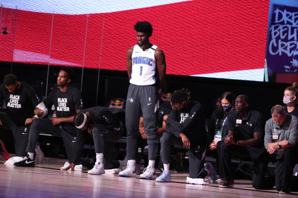 Jonathan Isaac of the Orlando Magic stands for the National Anthem prior to the game against the Brooklyn Nets during a scrimmage on July 31, 2020 at...