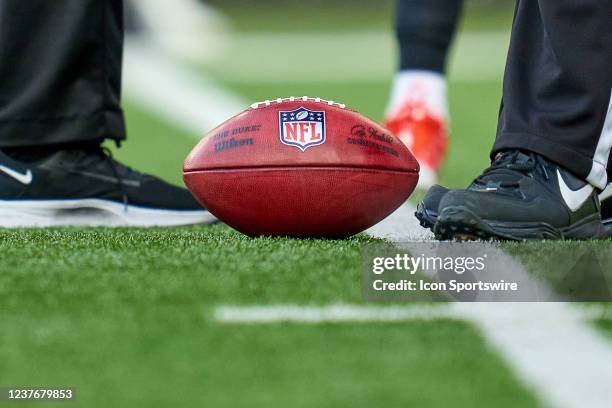 Detail view of a NFL logo is seen on the game ball in the field between two referees during a game between the Cincinnati Bengals and the Baltimore...