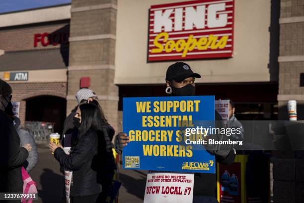 Union workers hold signs during a strike outside a King Soopers grocery store location in Broomfield, Colorado, U.S., on Wednesday, Jan. 12, 2022....