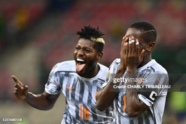 Ivory Coast's forward Max-Alain Gradel celebrates with teammate after scoring a goal during the Group E Africa Cup of Nations 2021 football match...