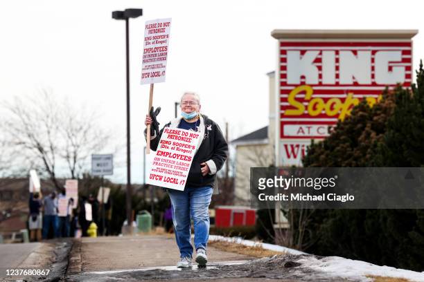 King Soopers grocery store worker waves a sign as employees strike at more than 70 stores across the Denver metro area on January 12, 2022 in...
