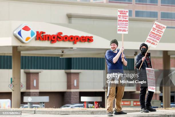 King Soopers grocery store workers wave signs as they strike at more than 70 stores across the Denver metro area on January 12, 2022 in Glendale,...