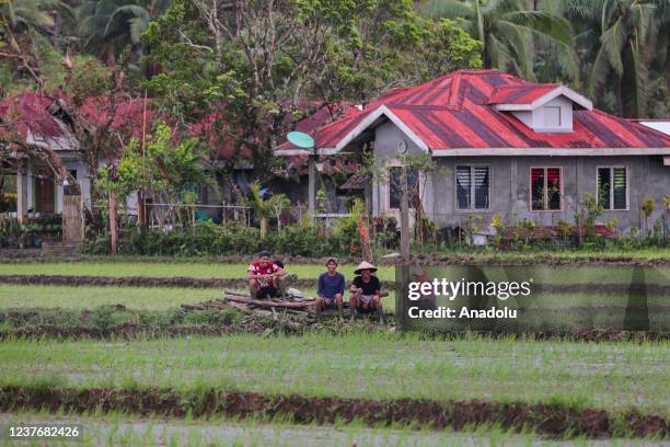 Farmers plant rice in the field in Gigaquit, Surigao del Norte, Philippines on January 12, 2022 as planting season has already been delayed due to...