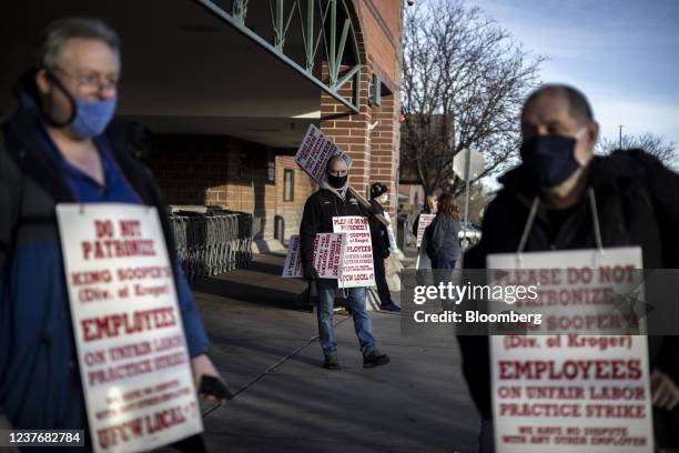 Union workers hold signs during a strike outside a King Soopers grocery store location in Westminster, Colorado, U.S., on Wednesday, Jan. 12, 2022....