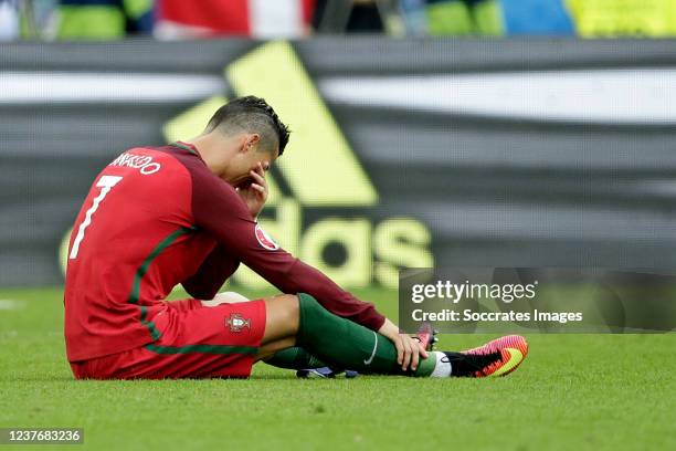 Cristiano Ronaldo of Portugal crying injured on the ground during the EURO match between France v Portugal at the Stade de France on July 10, 2016 in...