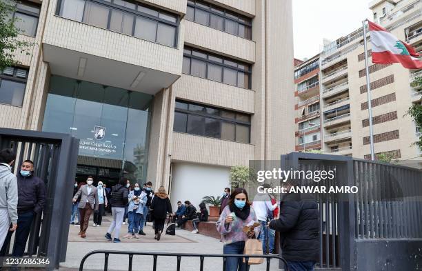 University students arrive to the campus of Beirut Arab Univesity in the Lebanese capital, on January 10, 2022. - Power shortages and soaring petrol...