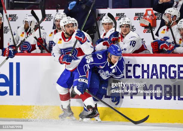 Daniel Walcott of the Syracuse Crunch squeezes past Peter Abbandonato of the Laval Rocket during the third period at Place Bell on January 12, 2022...