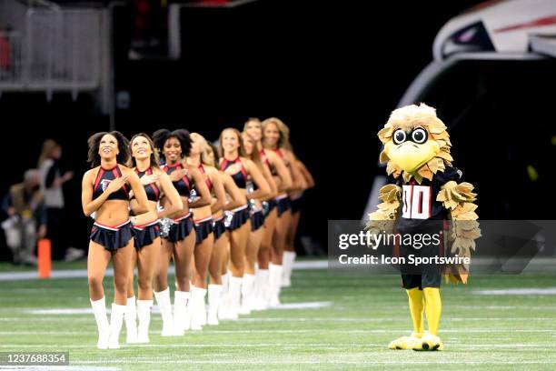 Falcons mascot Freddie and the Falcons cheerleaders wait on the National Anthem prior to the final NFL regular season game between the Atlanta...