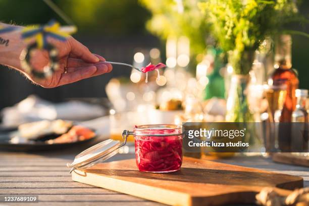 pickled onion at midsummer dinner in sweden - pickle jar stock pictures, royalty-free photos & images