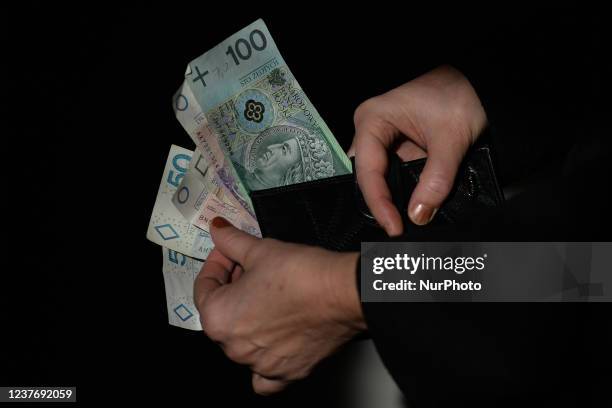 In this photo illustration a nitizen holds Polish Zloty banknotes. On Wednesday, January 12 in Edmonton, Alberta, Canada.