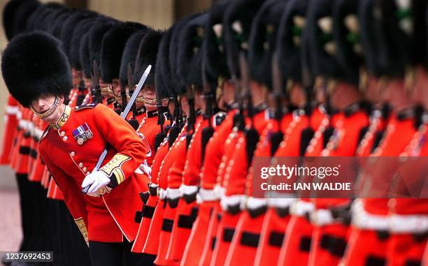 Member of the guard of honour at Buckingham Palace looks down the line to adjust position as they wait for an inspection by King Abdullah of Jordan...