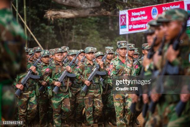 This photo taken on January 12, 2022 shows soldiers from the Taaung National Liberation Army , a Palaung ethnic armed group, parading as they mark...