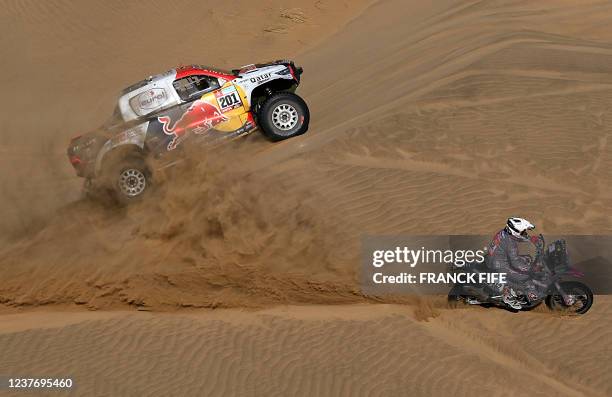 Toyota's driver Nasser Al-Attiyah of Qatar and his co-driver Matthieu Baumel of France compete during the Stage 11 of the Dakar 2022 around Bisha,...