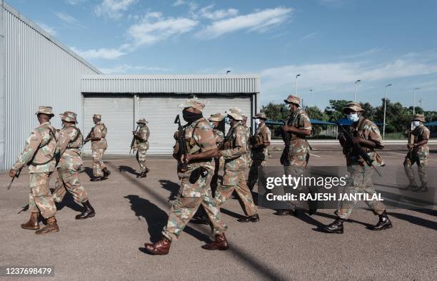 Members of the South African National Defence Force walk as they take part in an integrated multi-disciplinary law enforcement operation targeted at...