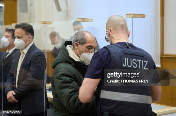 Former Syrian intelligence officer Anwar Raslan is led by a judicial officer into the courtroom at a courthouse in Koblenz, western Germany, on...