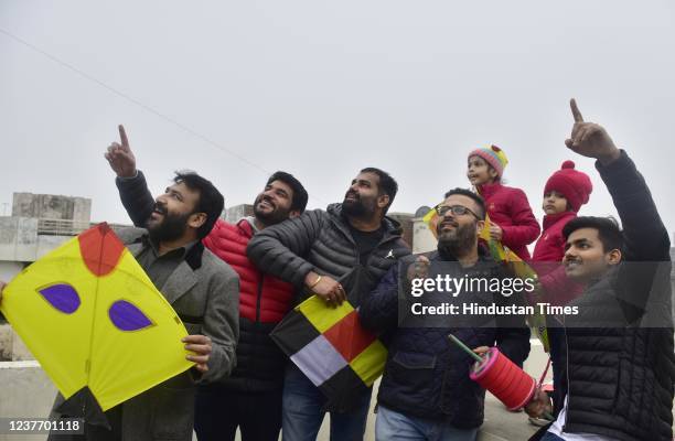 Young men fly kites on the occasion of Lohri festival, on January 13, 2021 in Amritsar, India.