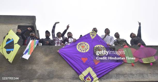 Young men fly kites on the occasion of Lohri festival, on January 13, 2021 in Amritsar, India.