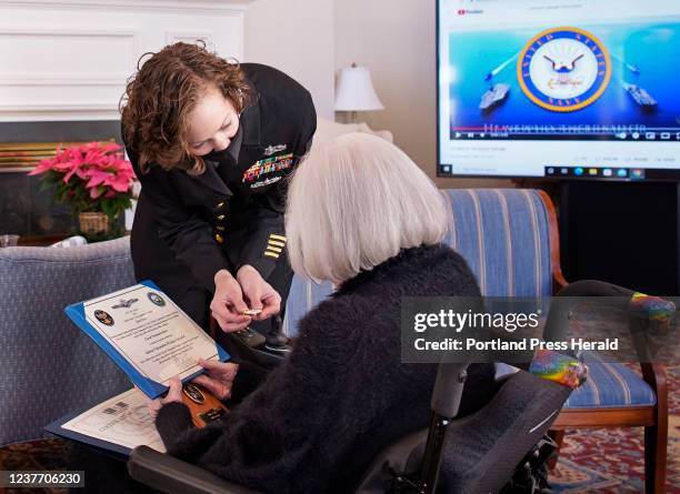 Chief Petty Officer Alyssa Sasnett presents a U.S. Navy cryptologist pin to Jane Case, who served as a code girl in the U.S. Navy WAVES during World...