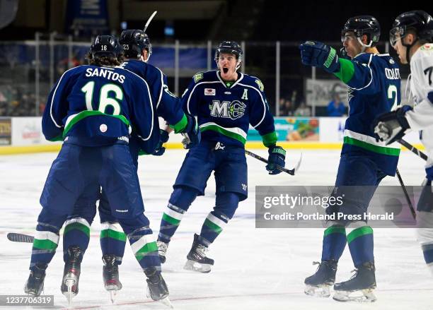 The Maine Mariners celebrate a first period goal against Worcester Railers Wednesday, December 29, 2021. L to R: Mathew Santos, Alex Kile, Brycen...