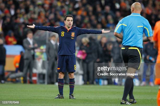 Xavi Hernandez of Spain, Referee Howard Webb during the World Cup match between Holland v Spain on July 11, 2010