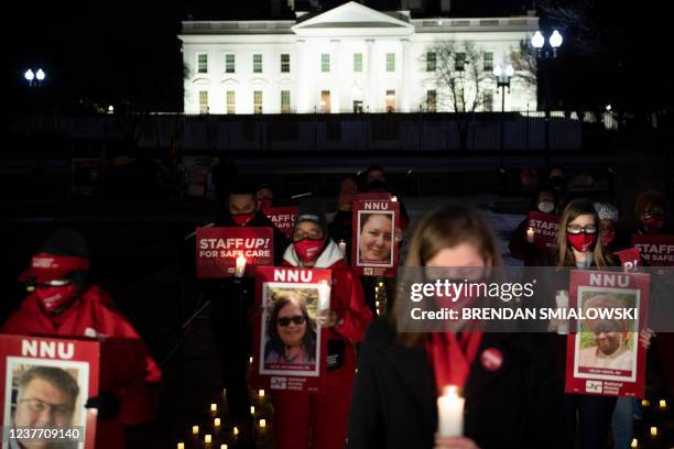 Activists gather during a vigil in Lafayette Park for nurses who died during the COVID-19 pandemic on January 13 in Washington, DC.