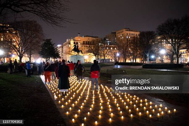 Activists gather during a vigil in Lafayette Park for nurses who died during the COVID-19 pandemic on January 13 in Washington, DC.