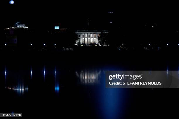 The White House is seen at night in Washington, DC on January 13, 2022.