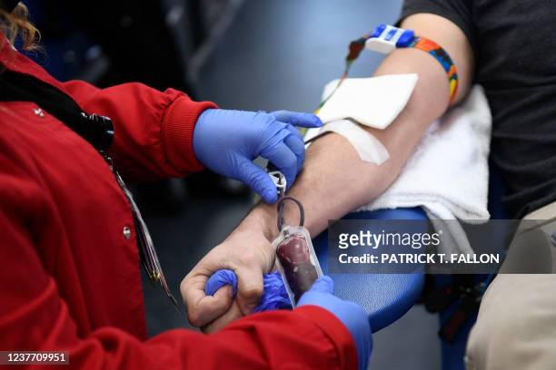 Person donates blood during a Children's Hospital Los Angeles blood donation drive in the LA Kings blood mobile outside the Crypto.com Arena on...