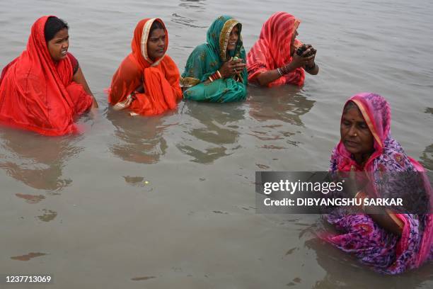 Hindu pilgrims take a holy dip at the confluence of Ganges and the Bay of Bengal during the Gangasagar Mela on the occasion of Makar Sankranti, a day...