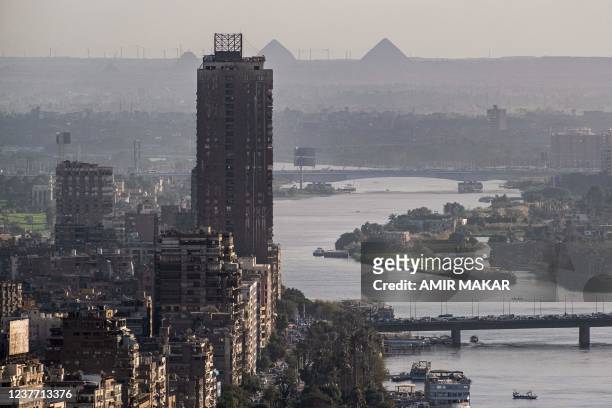 This picture taken on January 13, 2022 from the landmark Cairo Tower shows a view of the skyline of the Nile river island of Manial al-Roda in...