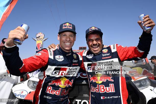 Toyota's driver Nasser al-Attiyah of Qatar and his co-driver Matthieu Baumel of France celebrates their victory after winning the Dakar Rally 2022,...