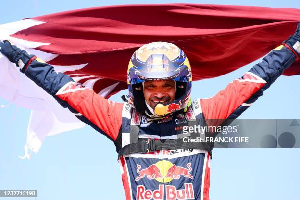 Toyota's driver Nasser Al-Attiyah of Qatar celebrates his victory after winning the Dakar Rally 2022, at the end of the last stage between Bisha and...