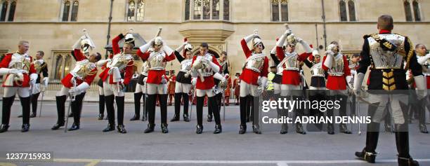 Members of the Household Cavalry are ordered to put their helmets on while getting ready to go on parade at The Houses of Parliament in preparation...