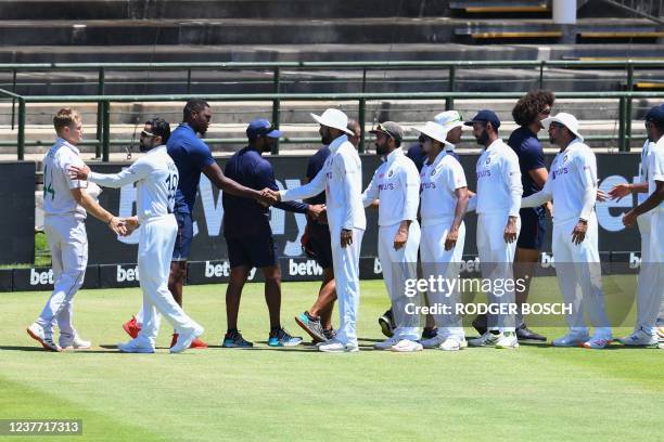 India players congratulate South Africa plyers after South Africa won the third Test cricket match between South Africa and India at Newlands stadium...