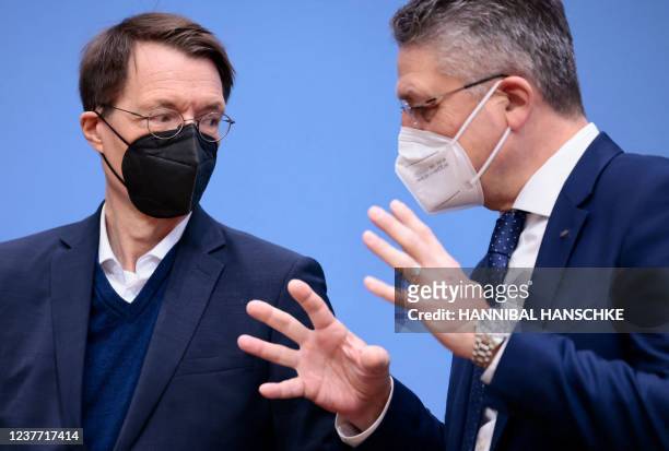 German Health Minister Karl Lauterbach and Robert-Koch-Institute President Lothar Wieler talk prior to a press conference on the situation of the...
