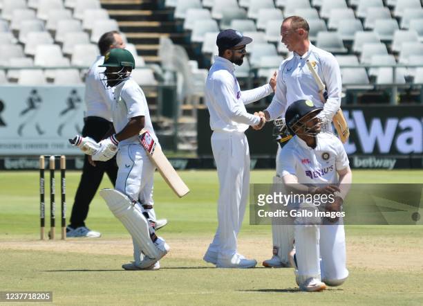 Virat Kohli of India congratulates Rassie van der Dussen and Temba Bavuma of South Africa on winning the match and test series during day 4 of the...