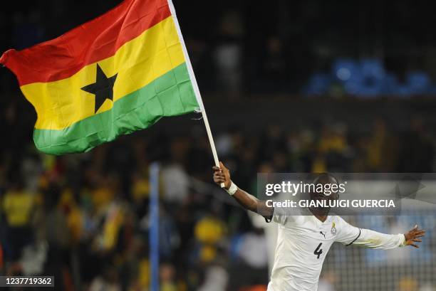 Ghana's defender John Paintsil celebrates with his national flag at the end of the Group D first round 2010 World Cup football match Serbia vs Ghana...