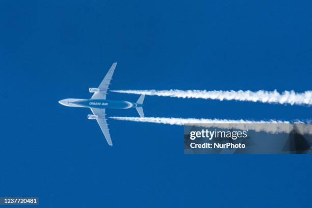 Oman Air Airbus A330 wide-body aircraft as seen flying at 40.000 feet of the Dutch city of Eindhoven during a clear blue sky day. The airline is the...