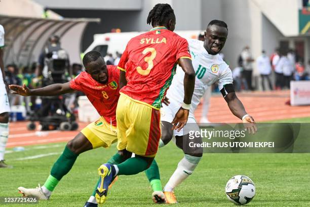 Guinea's midfielder Naby Keita and Guinea's defender Issiaga Sylla fight for the ball wtih Senegal's forward Sadio Mane during the Group B Africa Cup...